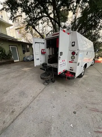 Magnet Plumbing service vehicle on-site for Grease Trap Cleaning in John J Delaney Homes